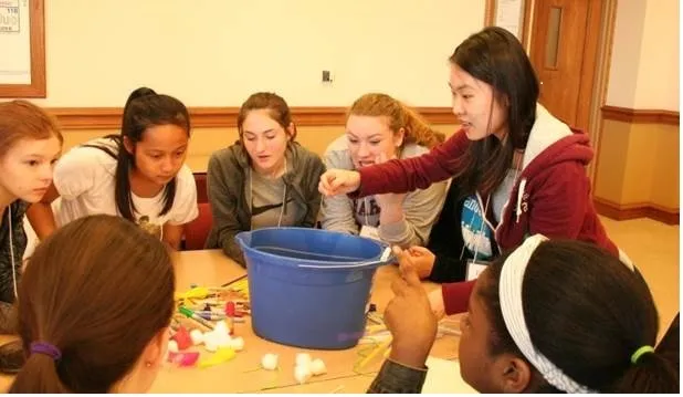 Graduate student Ying Zhang demonstrating a physics experiment 